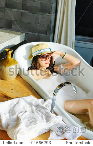 woman washing in bubble bath.