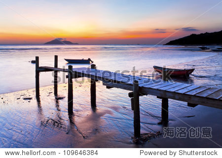 sunset coast at wooden pier