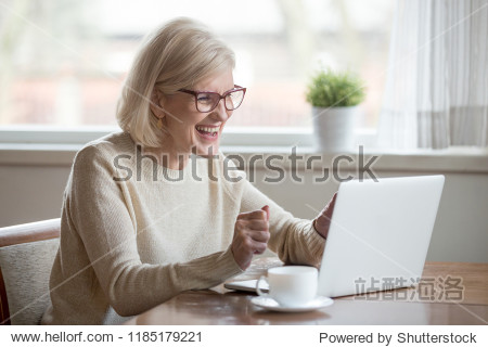happy mature middle aged elderly business woman winner excited
