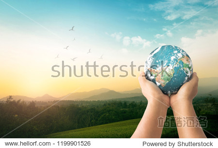 World environment day concept: Human hands holding earth global over mountain sunrise background. Elements of this image furnished by NASA