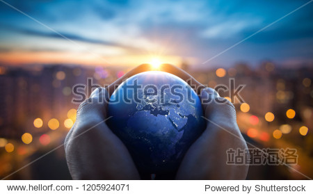 The globe Earth in the hands of man against the night city. Concept on business politics ecology and media. Earth day abstract background. Elements of this image furnished by NASA.