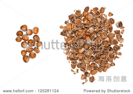 pile of nuts and a pile of empty nutshells isolated on white