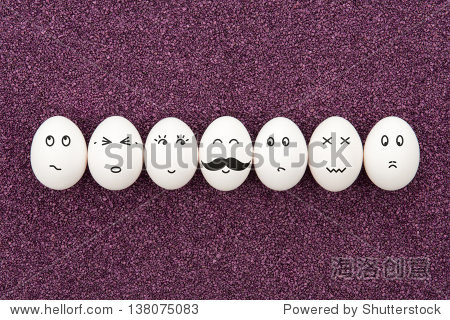 seven eggs with different facial expressions are lying on the