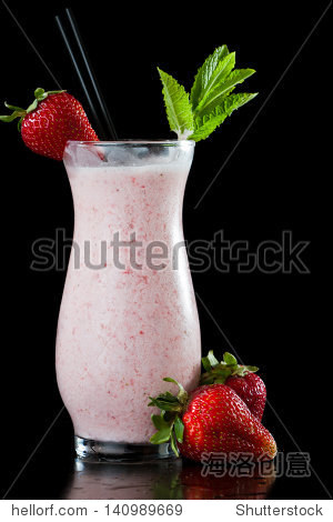 strawberry milk shake isolated on a black background garnished