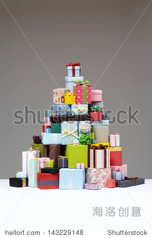 wrapped presents stacked in the form of a pyramid with cute gift