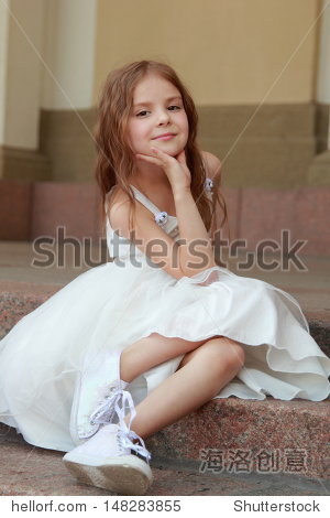 smiling cheerful little girl in a beautiful white