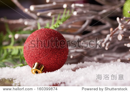 red christmas bauble ornament with wooden branch