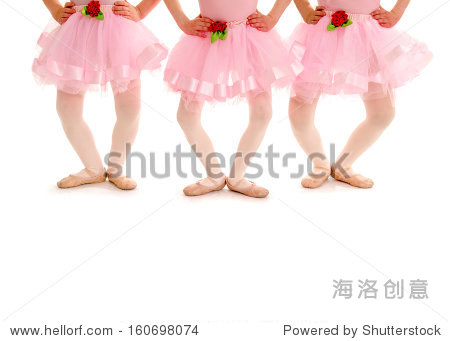 small girls in ballet recital costume and slippers pose in plie