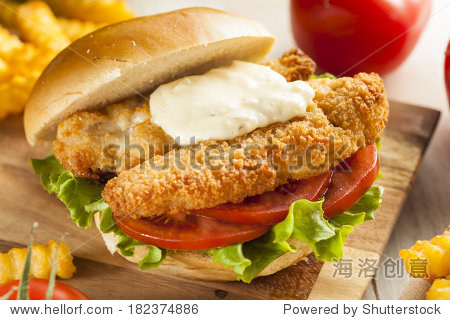 breaded fish sandwich with tartar sauce and fries