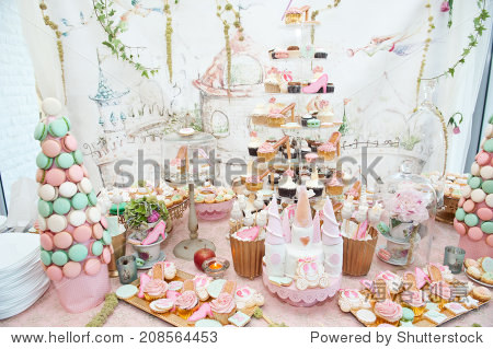 wedding decoration with pastel colored cupcakes meringues