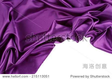 closeup of purple silk fabric on plain background