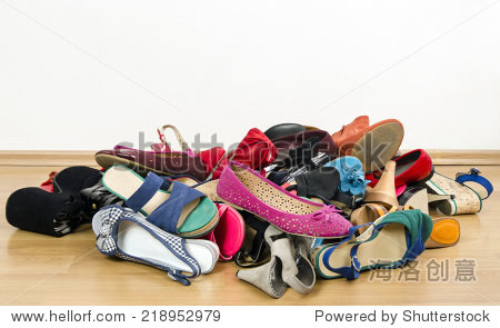 untidy stack of shoes thrown on the ground.