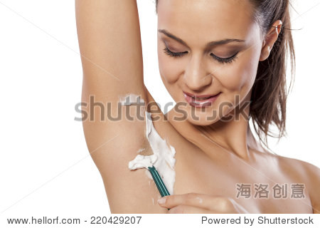 young beautiful woman shaving her armpits