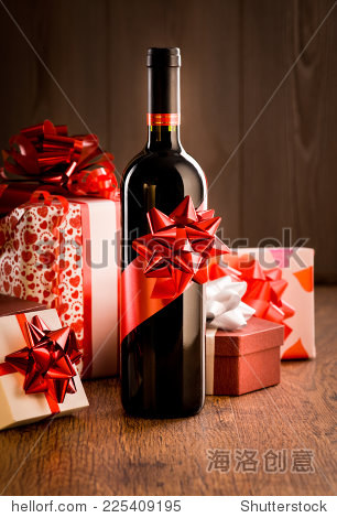 wine bottle gift with red ribbon and colorful christmas gift