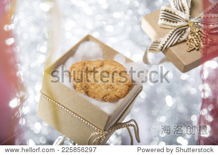 open christmas gift box with cookie ribbon and bow