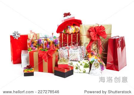 a pile of christmas gifts in colorful wrapping with ribbons.