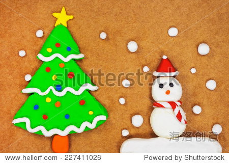 snowman and christmas tree made from modeling clay on brown