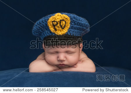 twelve day old sleeping newborn baby boy wearing a blue crochet