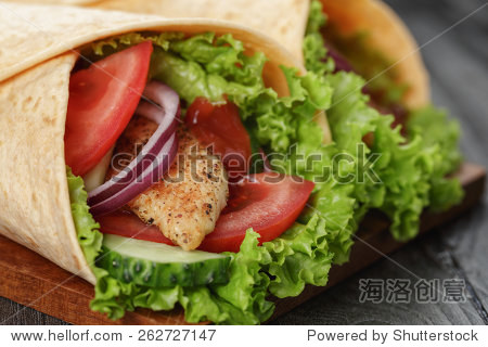 pair of fresh juicy tortilla wraps with chicken and vegetables