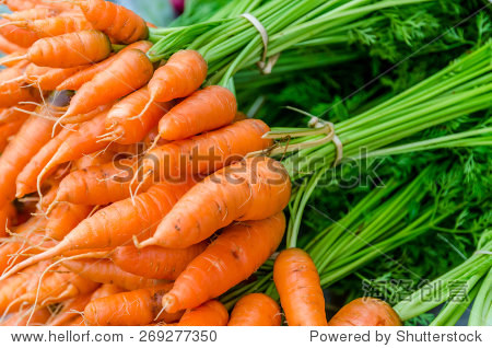 orange baby carrots piled on the table in local market