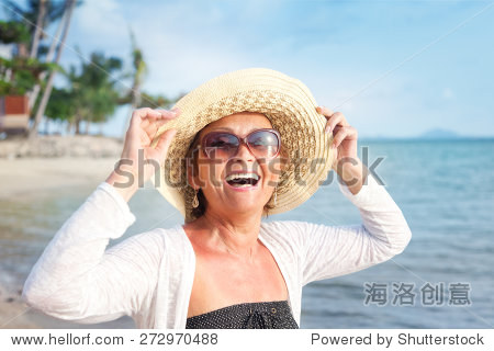 happy mature woman of 50 years on the beach