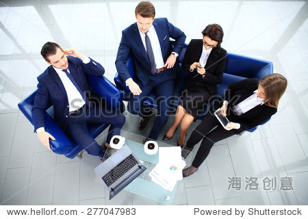 view of working business group sitting at table during corporate