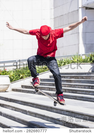 skateboarder doing a skateboard jumping trick from stairs