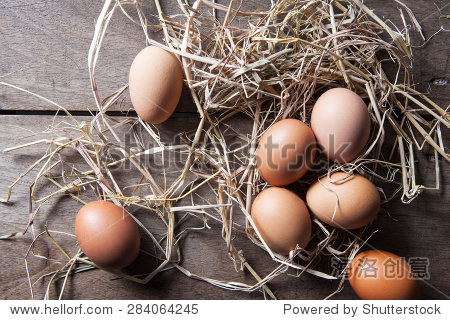 fresh eggs on rice straw at country farm top view still life