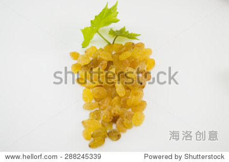bunch of raisins and grape leaf on white background
