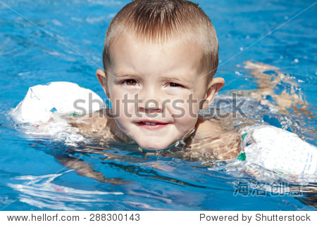 portrait of little baby boy swimming in the swimming pool