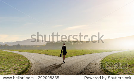 back view of businesswoman standing on crossroads and making