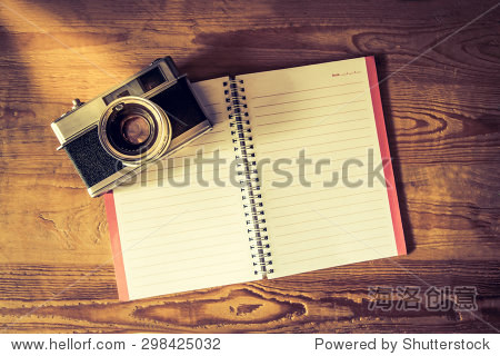 空白笔记本和钢笔复古相机古典风格的木制的桌