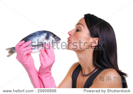 woman in pink rubber gloves about to kiss a fish isolated on