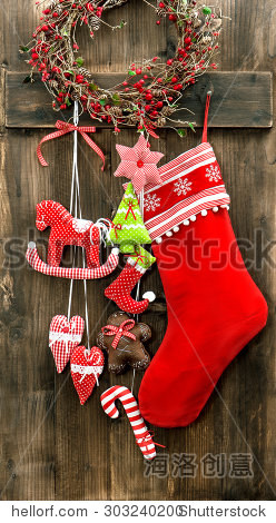 christmas stocking and handmade toys hanging over rustic wooden