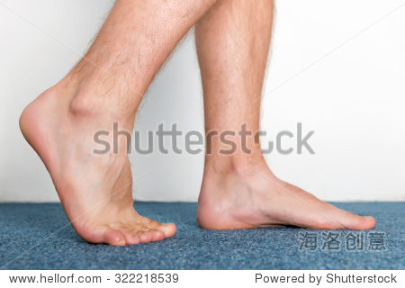 healthy male feet making a step over home-like background.