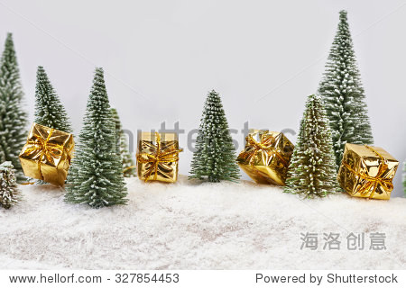 christmas gifts in gold packaging near toys trees