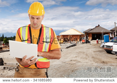 a construction worker using his computer on a new