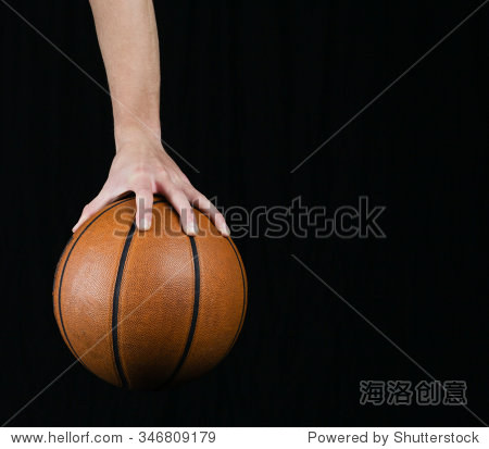 low key shot of a hand holding a basket ball