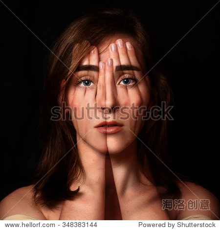 surreal portrait of a young girl covering her face and eyes with