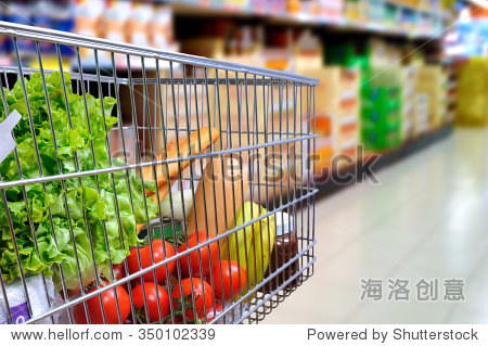 购物车满是食物在超市过道。一边倾斜。水平的