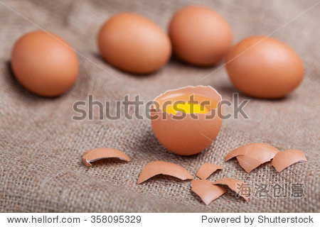 fresh eggs on sacking broken eggshell yolk