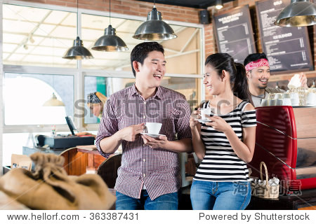 couple, woman and man, drinking cappuccino in coffee shop