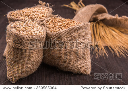 wheat and grain with cones on a dark wooden board