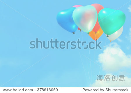the soft focus colorful heart-shaped balloons with blue sky in