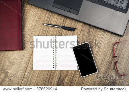 desk with laptop smartphone glasses calendar pen and notepad 