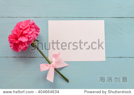 blank white greeting card with pink carnation flower and ribbon