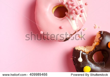 donuts with icing on pink background. sweet donuts.