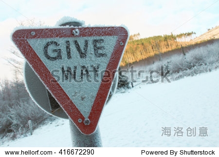 image of a give way sign that appears to be covered in frost and