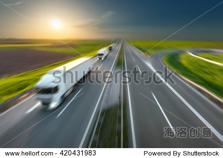 Three new trucks in a row driving fast towards t