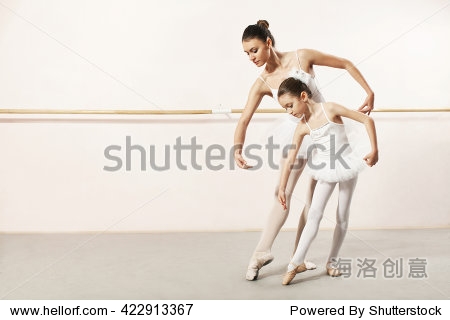 little ballerina dancing with ballet teacher in dance studio